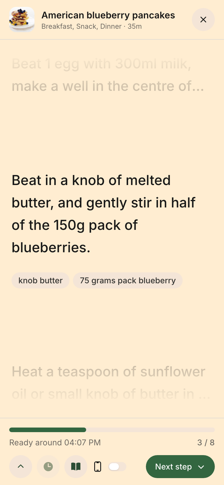 Cooking mode on a phone: the step with its ingredient chips, and the bottom bar carrying Ready At